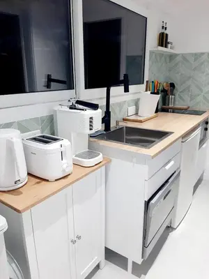 a kitchen with white appliances on a counter at Estancia el Sauce in Taglio-Isolaccio
