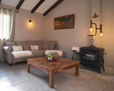 a living room with a couch and a coffee table at Casa Felice, Bergerie en pierre, jacuzzi, jardin in San-Gavino-di-Carbini