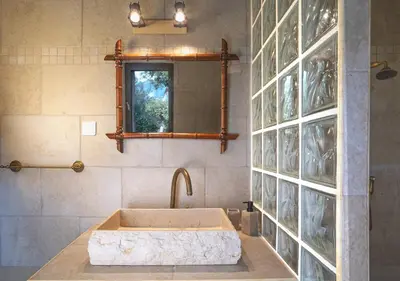 a bathroom with a large sink and a mirror at Casa Felice, Bergerie en pierre, jacuzzi, jardin in San-Gavino-di-Carbini