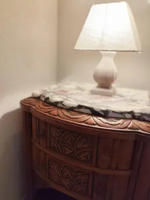 a table with a lamp on top of it at Casa Felice, Bergerie en pierre, jacuzzi, jardin in San-Gavino-di-Carbini