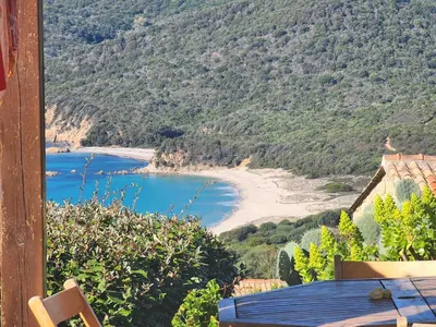 a view of a beach from the balcony of a house at Mini-villa 4 personnes - Soléa 20 - vue mer in Serra-di-Ferro