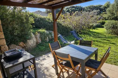 a table and four chairs on a patio at Mini-villa 4 personnes - Soléa 20 - vue mer in Serra-di-Ferro