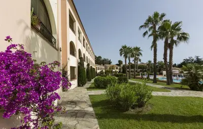 a building with purple flowers on the side of it at T2 - 200 m from the sea in Linguizzetta