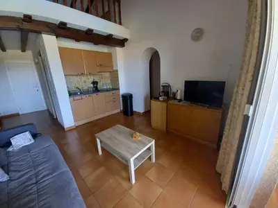 a living room with a couch and a table at CORSE Bravone bel appart à 2 pas de la plage 2ch et mezzanine in Linguizzetta