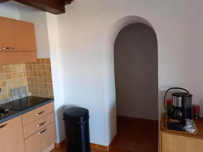a kitchen with a trash can in the corner of a room at CORSE Bravone bel appart à 2 pas de la plage 2ch et mezzanine in Linguizzetta