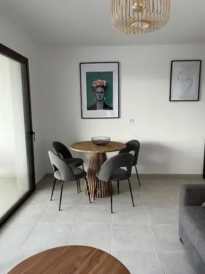 a dining room with a table and chairs at Loc A Machia Fiurita 2 - Vue mer in Pietrosella