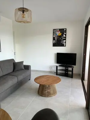 a living room with a couch and a coffee table at Loc A Machia Fiurita 2 - Vue mer in Pietrosella