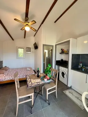 a room with a dining table and a bed at Luce di Mare Studio - Near Santa-Giulia in Porto-Vecchio