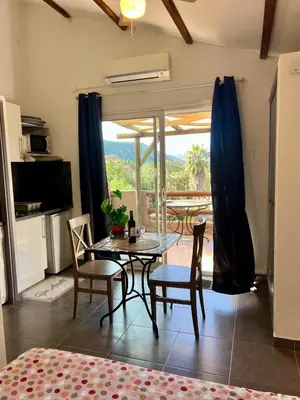 a kitchen and dining room with a table and chairs at Luce di Mare Studio - Near Santa-Giulia in Porto-Vecchio
