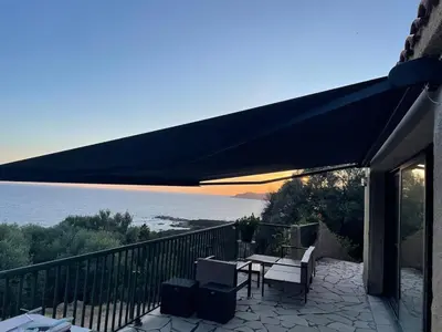 a patio with a table and chairs on a balcony at Corse villa sea view 180 AC 4 bedeooms sleeps 10 in Serra-di-Ferro