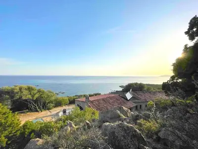 a house on a hill with the ocean in the background at Corse villa sea view 180 AC 4 bedeooms sleeps 10 in Serra-di-Ferro