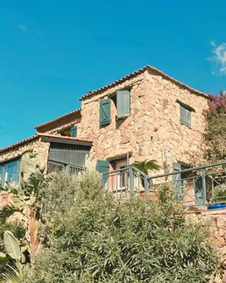 a stone house with green shuttered windows and trees at Private pool villa Beach 50 m away 10 guests in Sartène