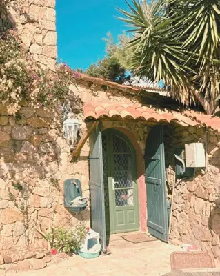 an entrance to a stone building with a green door at Private pool villa Beach 50 m away 10 guests in Sartène