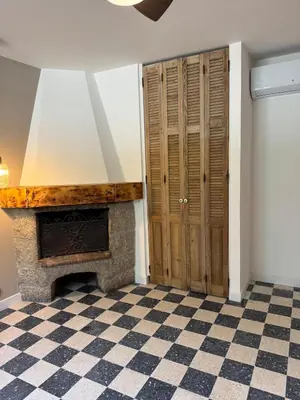 a room with two windows and a checkered floor at Maison typique Corse en pleine nature in Fozzano