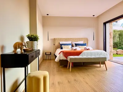a bedroom with a bed with a dog on it at Villa di Stella Pinarello - Proche plage - swimming pools in Sainte-Lucie de Porto-Vecchio