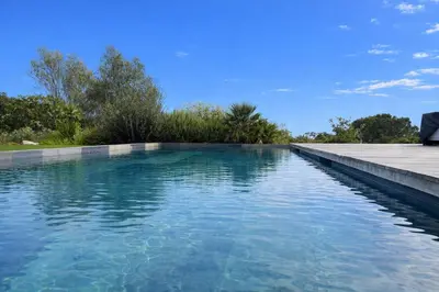 a swimming pool with clear blue water at Villa di Stella Pinarello - Proche plage - swimming pools in Sainte-Lucie de Porto-Vecchio