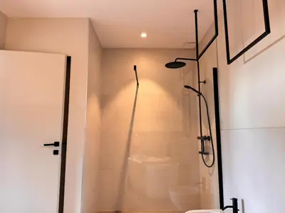 a bathroom with a shower with a glass door at Villa di Stella Pinarello - Proche plage - swimming pools in Sainte-Lucie de Porto-Vecchio