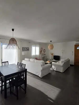 a living room with two white couches and a table at maison être mer et montagne in Ponte-Leccia