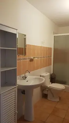 a bathroom with a sink and a toilet at domaine d alistro avec grande piscine in Canale-di-Verde