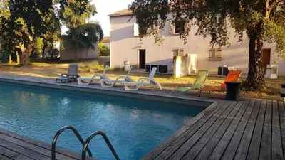 a group of chairs sitting next to a swimming pool at domaine d alistro avec grande piscine in Canale-di-Verde