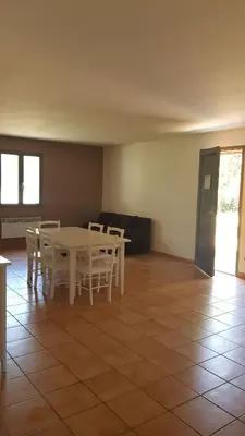 a dining room with a white table and chairs at domaine d alistro avec grande piscine in Canale-di-Verde