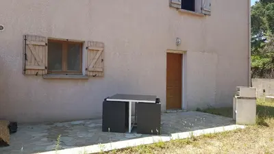 a appliance sitting outside of a building next to a door at domaine d alistro avec grande piscine in Canale-di-Verde