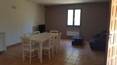 a dining room with a white table and chairs at domaine d alistro avec grande piscine in Canale-di-Verde