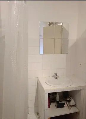 a white bathroom with a sink and a mirror at Maison typique village corse in Sari-dʼOrcino