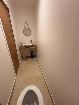 a bathroom with a toilet and a sink at Casa Nostra in Belgodère