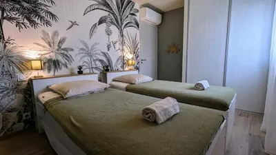 a bedroom with two beds with towels on them at T3 Casa di Giulia neuf grande terrasse - Lumineux - Plage à 5 min in Zonza