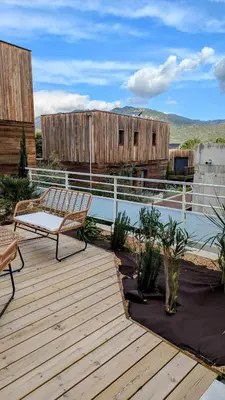 a wooden deck with a bench on top of a building at T3 Casa di Giulia neuf grande terrasse - Lumineux - Plage à 5 min in Zonza