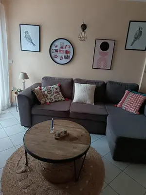 a living room with a couch and a coffee table at Authentique maison de hameau in Altagene