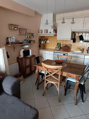 a kitchen with a wooden table and chairs in it at Authentique maison de hameau in Altagene