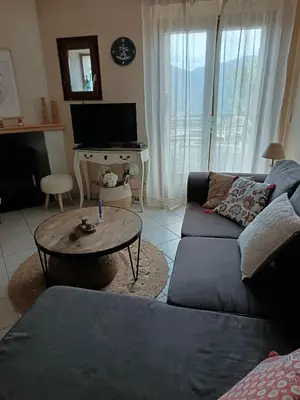 a living room with a couch and a table at Authentique maison de hameau in Altagene