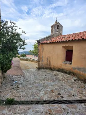 an old building with a small tower on top of it at Studio neuf , vue mer et montagne in Lavatoggio