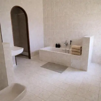 a white bathroom with a tub and a sink at Un étage entier - 5 chambres indépendantes et 3 salles de bains in Corte