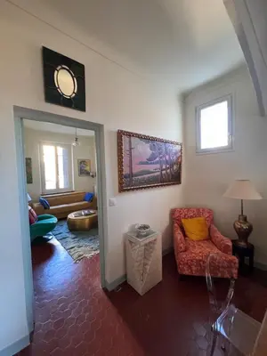 a living room with a couch and a chair at Elegant 2-bedroom terrace in the heart of the city in Ajaccio