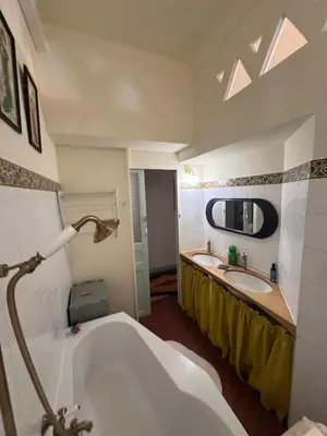 a bathroom with a tub and a sink at Elegant 2-bedroom terrace in the heart of the city in Ajaccio