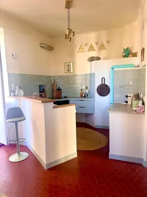 a kitchen with white counters and a counter top at Elegant 2-bedroom terrace in the heart of the city in Ajaccio