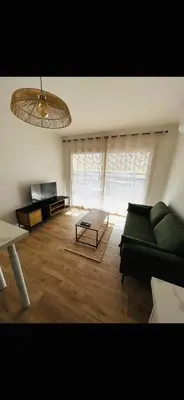 a living room with a green couch and a table at T2 Cosy Centre Ajaccio in Ajaccio