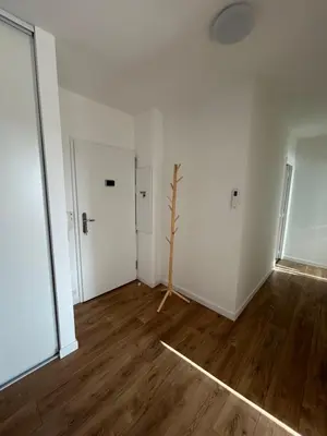 an empty room with white walls and wooden floors at T2 Cosy Centre Ajaccio in Ajaccio