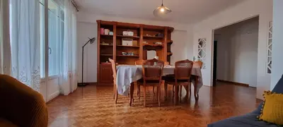 a dining room with a table and chairs at grand T3 centre ville climatisé in Corte