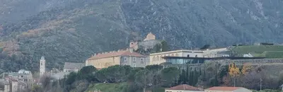 a large building on top of a mountain at grand T3 centre ville climatisé in Corte