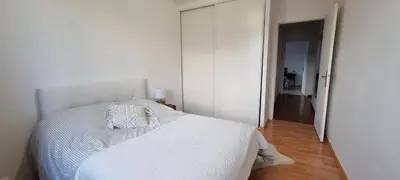 a bedroom with a white bed and a hallway at grand T3 centre ville climatisé in Corte