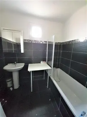 a bathroom with a sink and a bath tub next to a sink at grand T3 centre ville climatisé in Corte