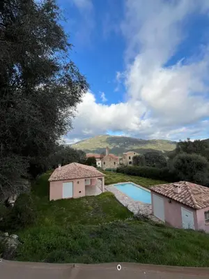 a house with a swimming pool and two buildings at Casa Alivu in Pietrosella