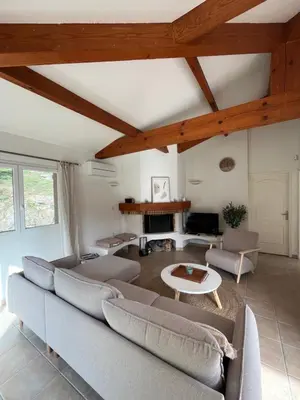 a living room with couches and a table at Casa Alivu in Pietrosella