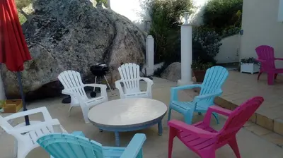 a group of colorful chairs and a table and chairs at Location familiale 6 personnes entre Propriano et Olmeto in Olmeto