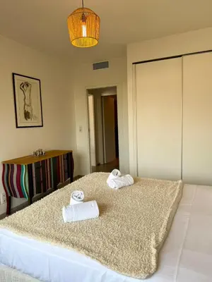 a bedroom with a bed with towels on it at Grand T2 vue mer à Propriano in Propriano