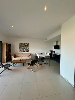 a living room with a couch and a table at Grand T2 vue mer à Propriano in Propriano